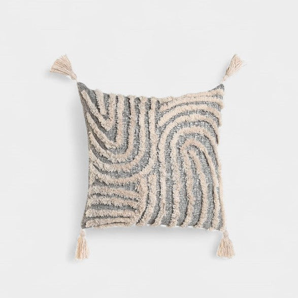Coussin gris et beige texturé à pompons